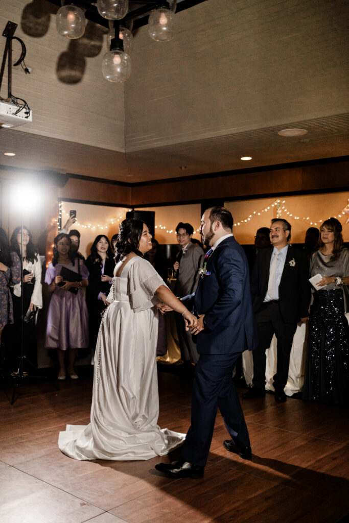 Bride and groom have their first dance together at this wedding at Seasons Restaurant