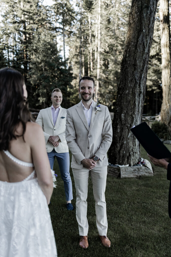 The groom smiles at his bride at the altar as the officiant marries them at their east sooke elopement.