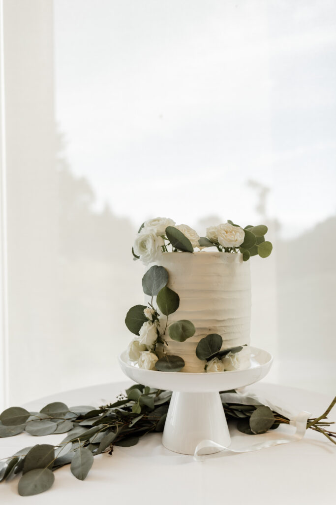 simple white cake with greenery at this Olympic View Golf Club wedding