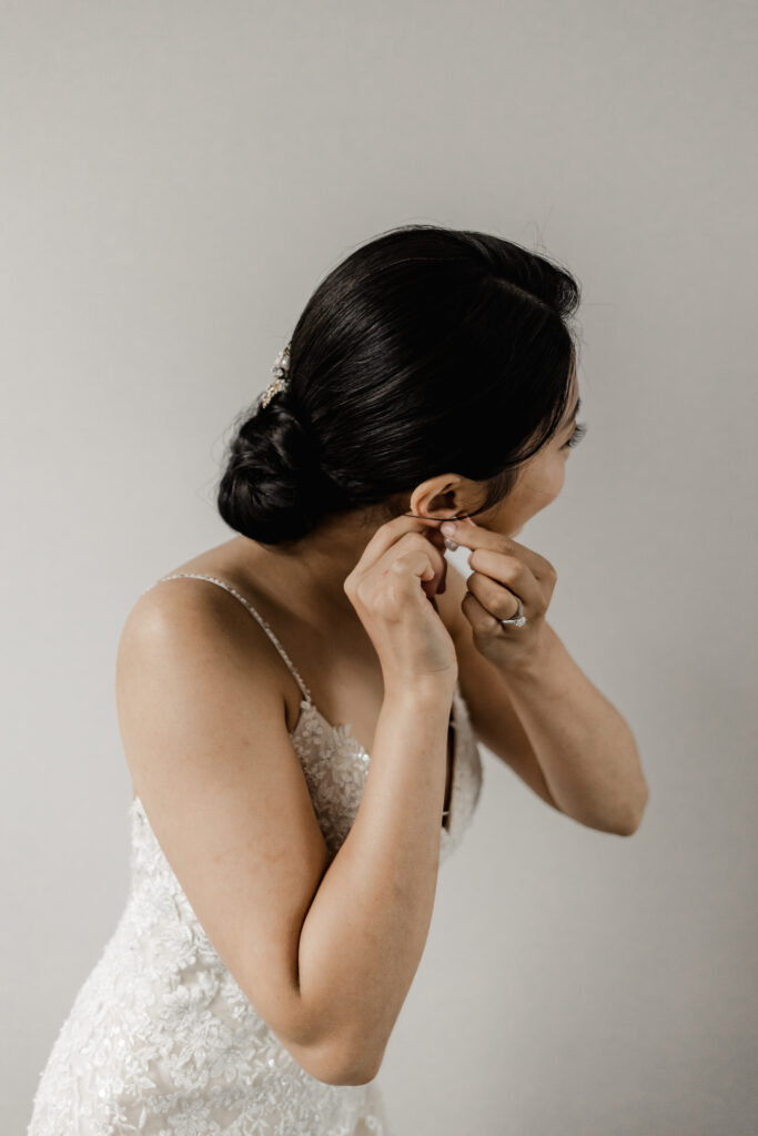 The brides put on her finishing touches at this Olympic View Golf Club wedding