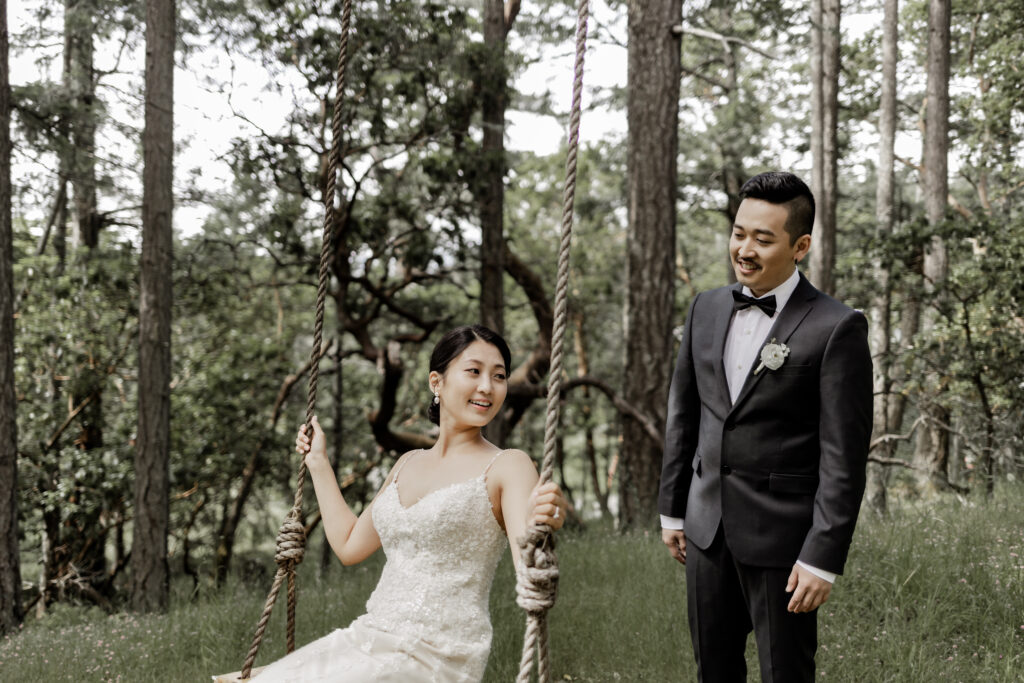 groom pushes bride on swing at Olympic View Golf Club wedding