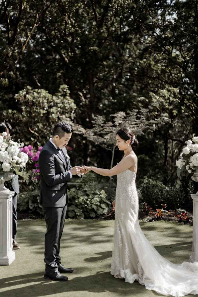 bride and groom exchange rings at this Olympic View Golf Club wedding