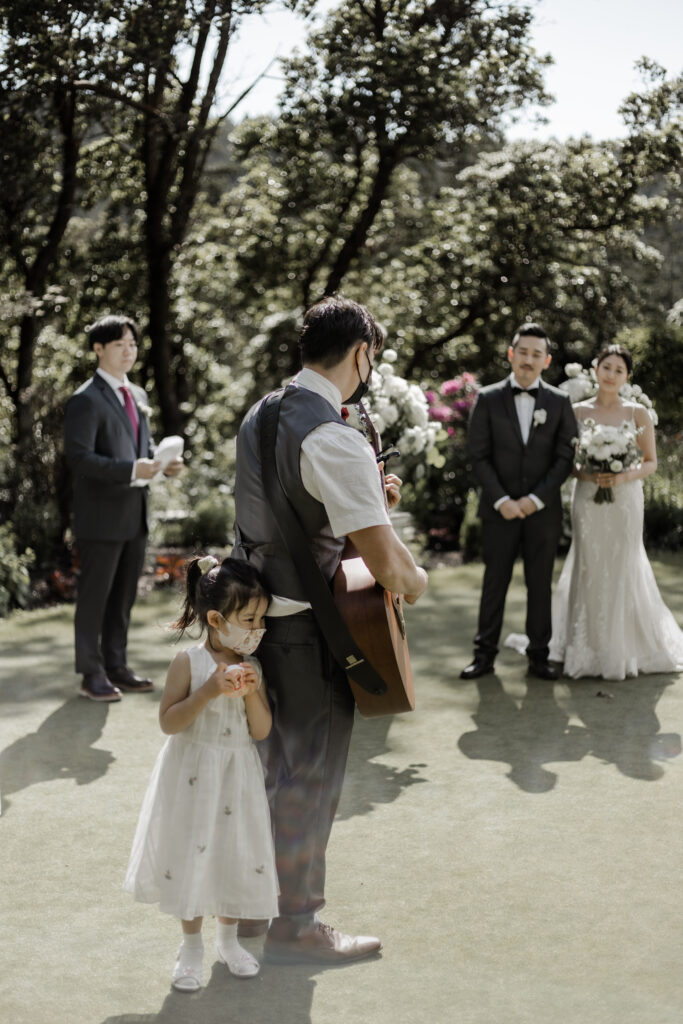 guest plays guitar and sings during ceremony at this Olympic View Golf Club wedding