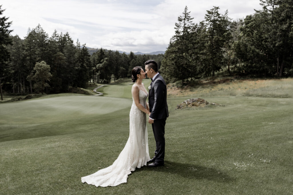 bride and groom in front of the golfing greens at this Olympic View Golf Club wedding