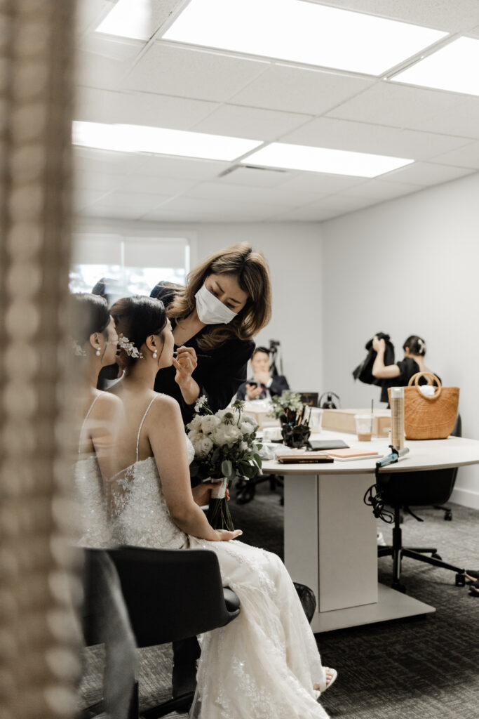 Bride gets makeup done at this Olympic View Golf Club wedding