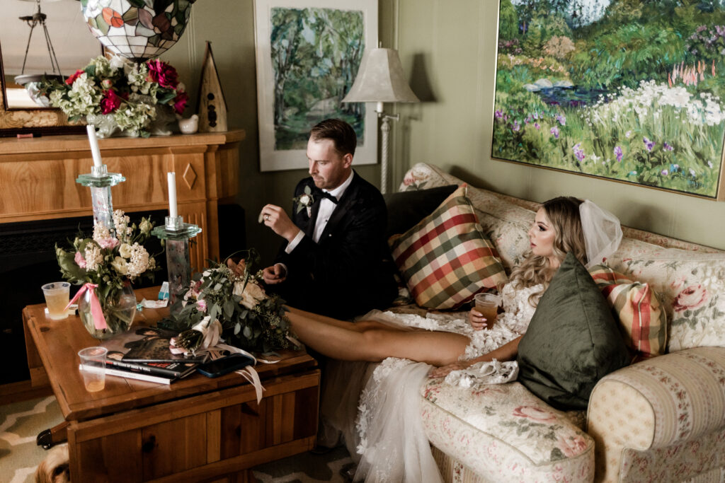 The bride and groom relax on the couch at this lakeside wedding at Alberta Beach