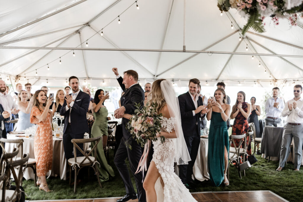 the bride and groom enter the reception at this lakeside wedding at Alberta Beach