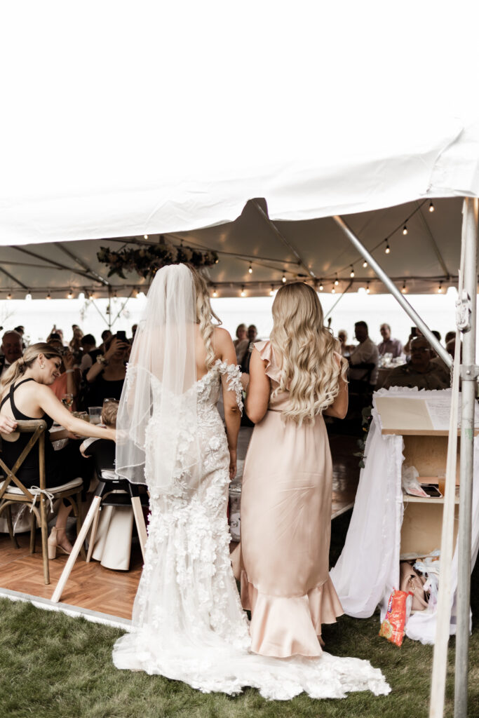 the bride and her sister sing for the guests at this lakeside wedding at Alberta Beach