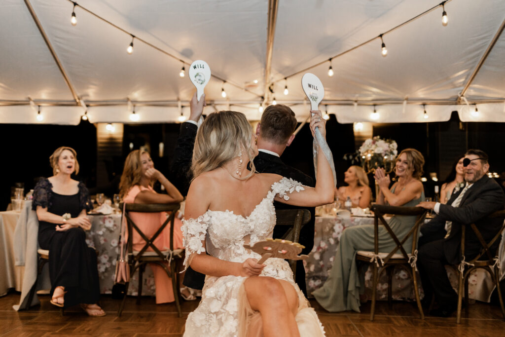 The bride and groom play the shoe game at this lakeside wedding at Alberta Beach