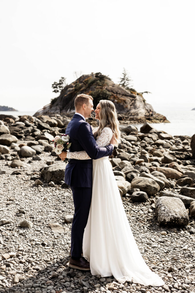 Bride and groom embrace each other at this Whytecliff Park elopement