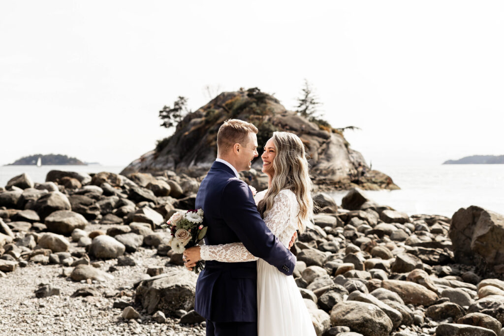 Bride and groom smile at each other at this Whytecliff Park elopement