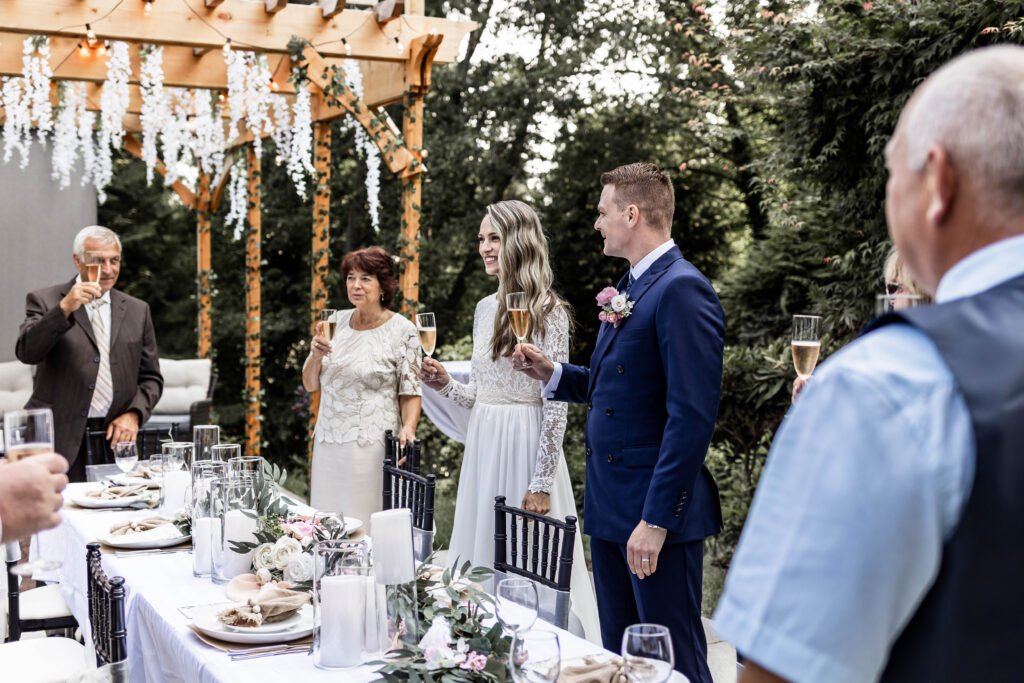 Bride and groom cheers champagne at their Whytecliff Park elopement reception