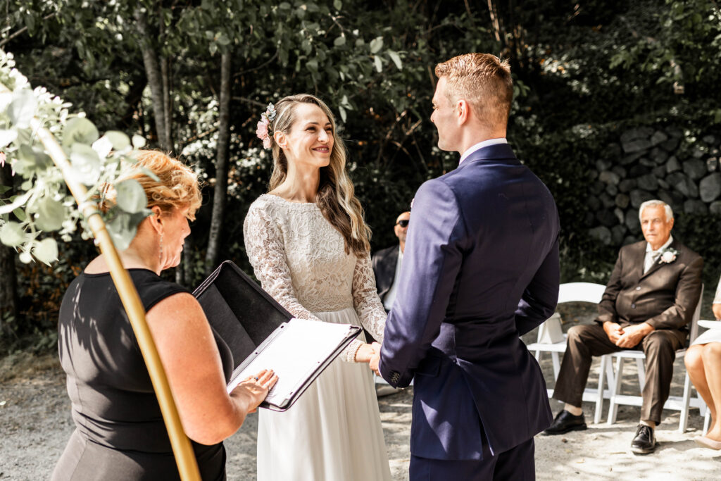 The bride smiles at her groom at the altar at this Whytecliff Park elopement