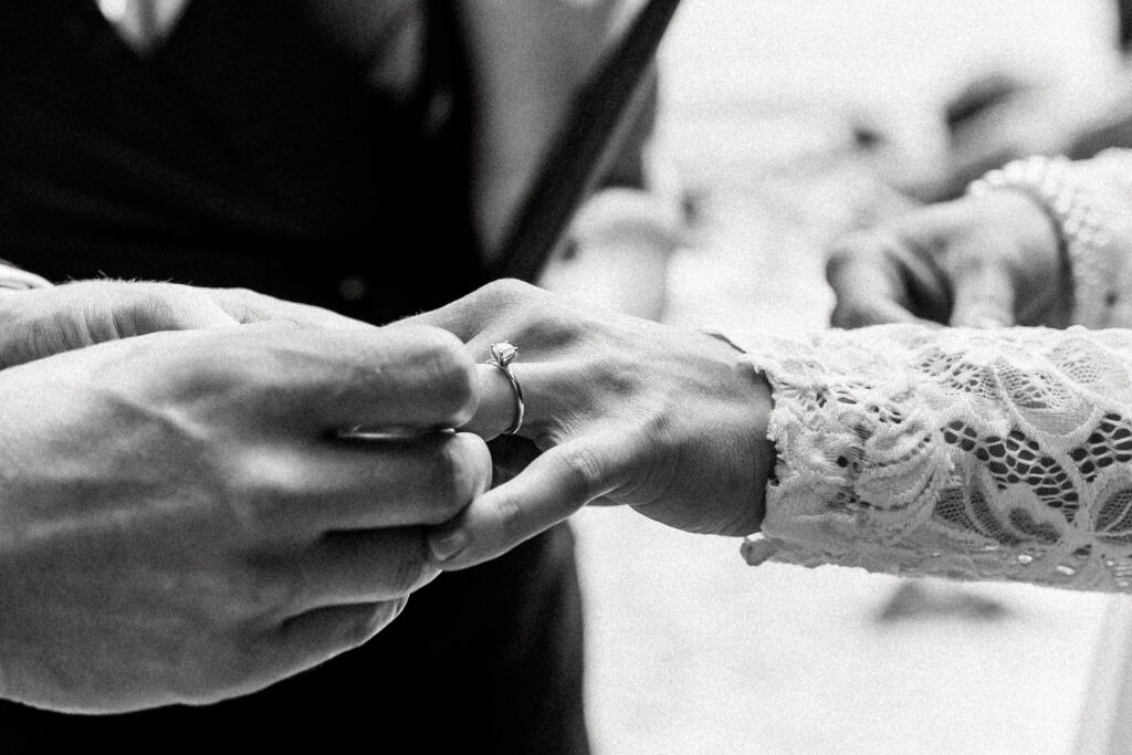 Groom puts ring on the bride's finger at this Whytecliff Park elopement