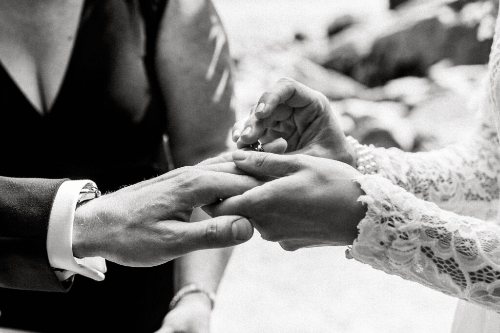 Bride puts ring on grooms finger at this Whytecliff Park elopement