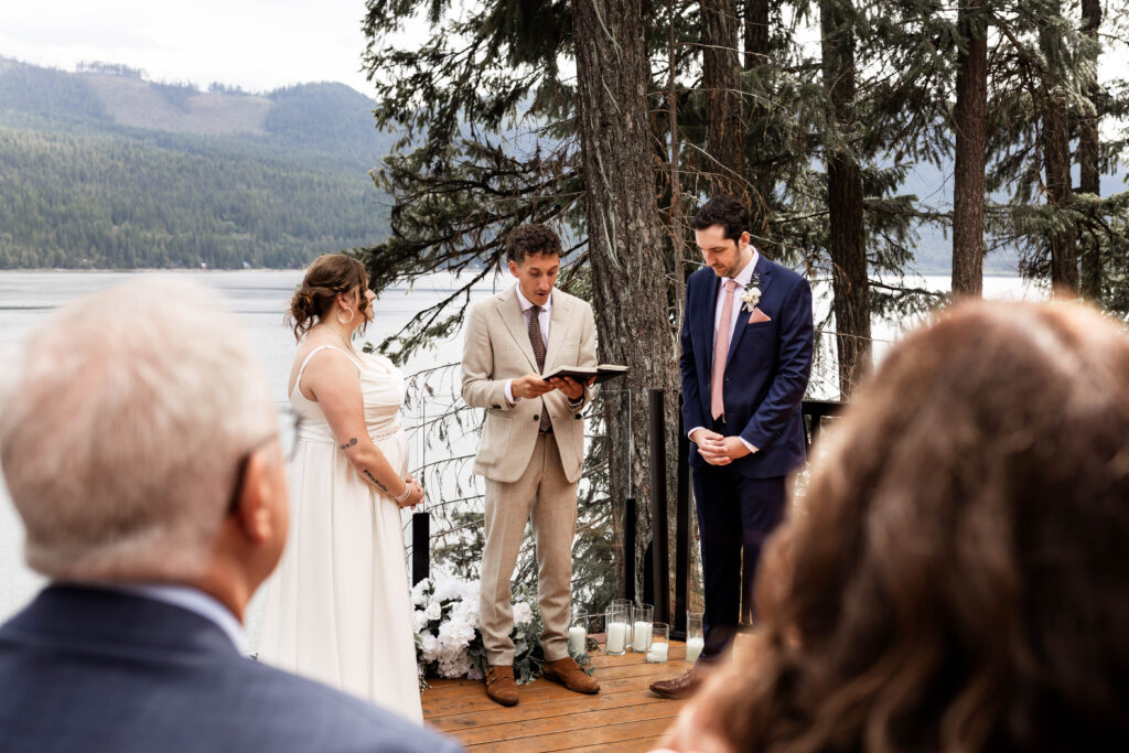 Bride and groom stand at the altar at their elopement overlooking Mabel Lake