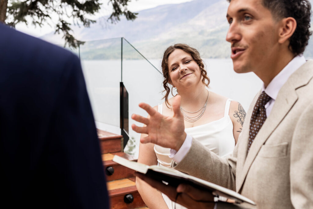 The bride smiles as the officiant speaks at their elopement ceremony