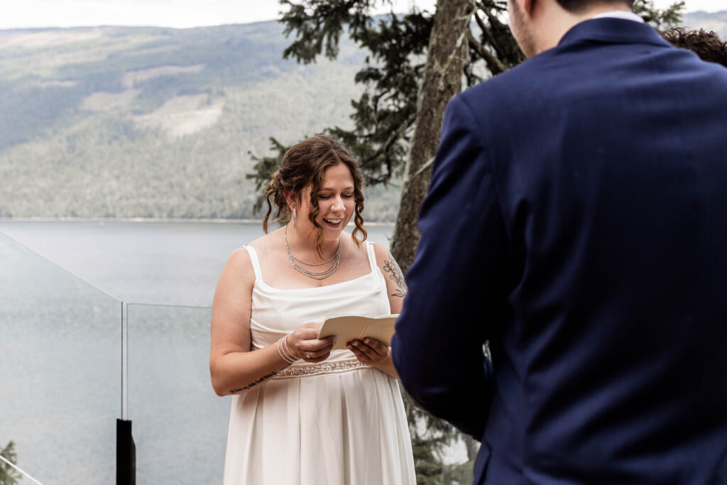 Bride smiles while reading her vows at this Mabel Lake elopement