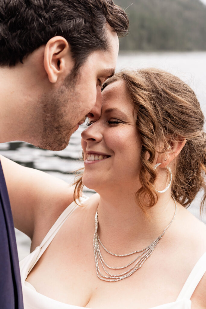 An up close of the bride and groom in front of Mabel Lake at their elopement