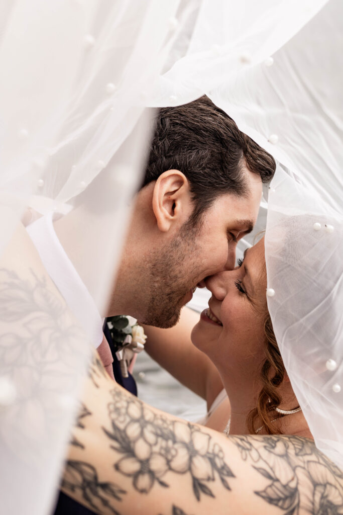 Up close of bride and groom underneath veil at this Mabel Lake elopement