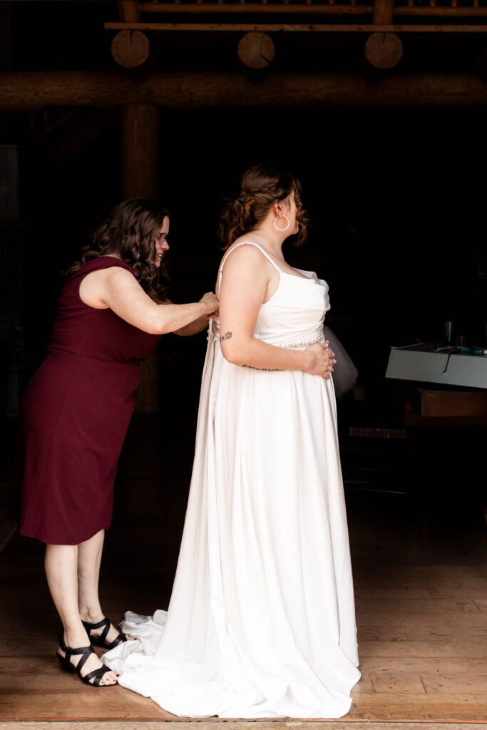 Bride's mom does up dress at this Mabel Lake elopement