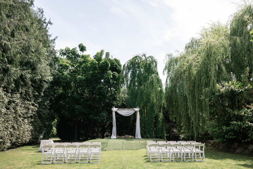 Wide shot of the outdoor ceremony space at the Secret Garden at Ripples Winery, a wedding venue in Abbotsford, BC.