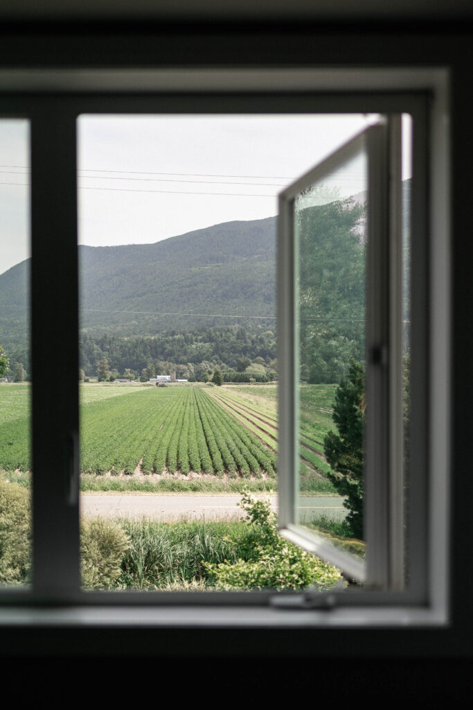 A view of the farmland from one of the rooms at the Bed and Breakfast at the Secret Garden at Ripples Winery, a wedding venue in Abbotsford, BC.