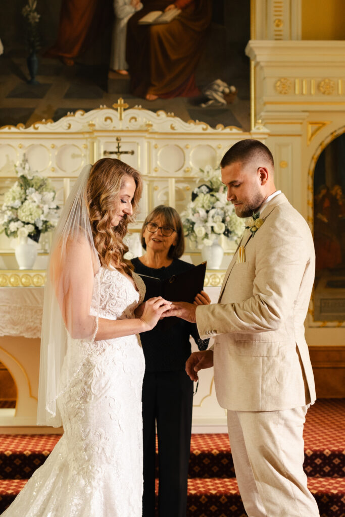 Couples exchanging rings at this Victoria Cathedral wedding in St. Ann's Academy