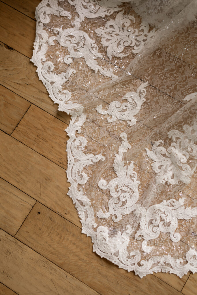 Up close of wedding dress train lace details during getting ready photos at Parkside hotel