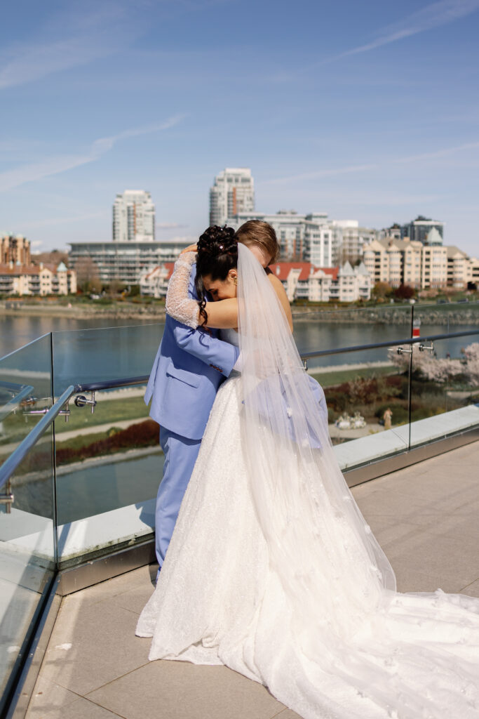 Bride and groom first look on a balcony at Laurel Point Inn wedding