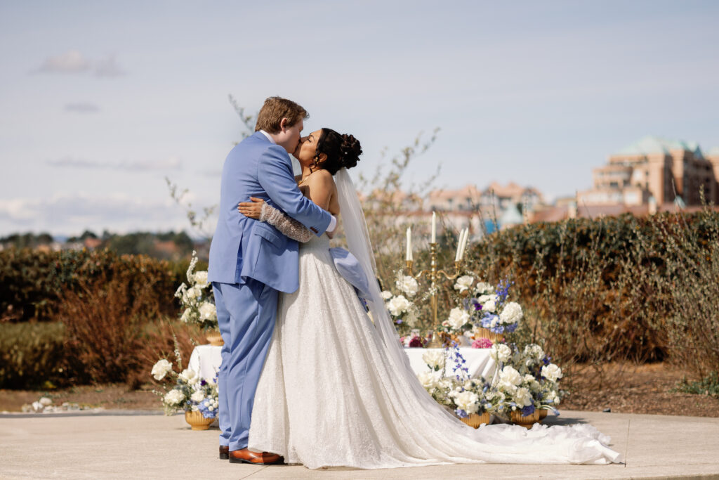 First kiss during a Laurel Point Inn wedding ceremony by the ocean