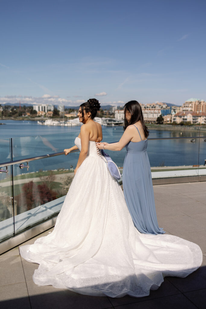 Bride getting ready in oceanfront suite during a Laurel Point Inn wedding in Victoria BC