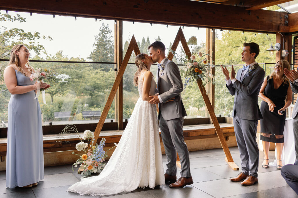 Elegant Shaughnessy wedding ceremony at VanDusen Gardens with glowing glass windows and intimate atmosphere