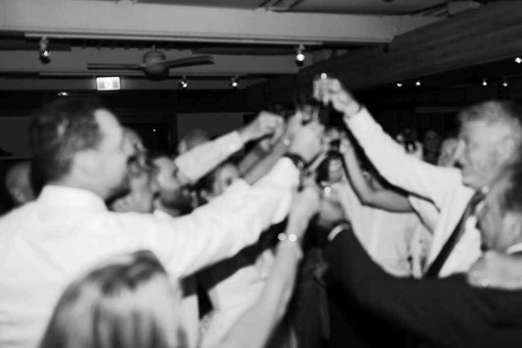 Guests cheersing on the dance floor at a lively Shaughnessy wedding reception